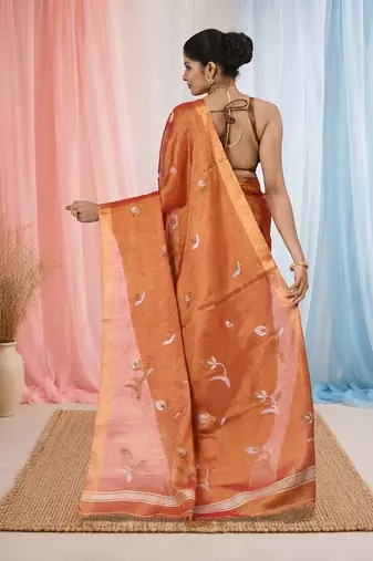 Orange tissue saree with ethnic motifs and golden border