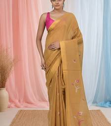 Beige tissue saree with ethnic motifs and golden border