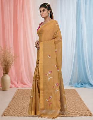 Beige tissue saree with ethnic motifs and golden border 2