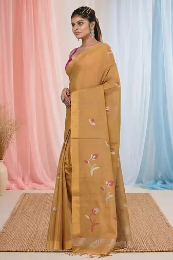 Beige tissue saree with ethnic motifs and golden border