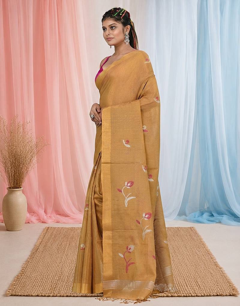 Beige tissue saree with ethnic motifs and golden border