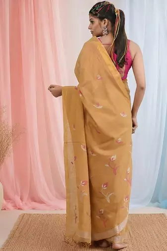 Beige tissue saree with ethnic motifs and golden border