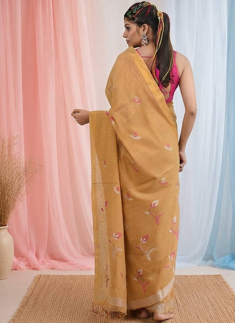Beige tissue saree with ethnic motifs and golden border