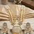 Antique gold-toned kundan pearl cluster necklace set with hexagonal meenakari pendant and pearl jhumka earrings