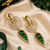 Gold finish emerald halo drop earrings
