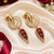 Gold finish ruby halo drop earrings