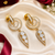 Gold finish white halo drop earrings