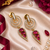 Gold finish ruby halo drop earrings