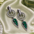 Black silver finish green halo drop earrings