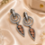 Black silver finish champagne halo drop earrings