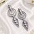 Black silver finish white halo drop earrings
