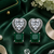 Rhodium finish heart halo emerald earrings