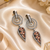 Black silver finish champagne halo drop earrings