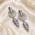 Black silver finish white halo drop earrings