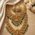 Temple jewelry set with goddess lakshmi pendant, peacock jhumkas & green beads - south indian bridal set