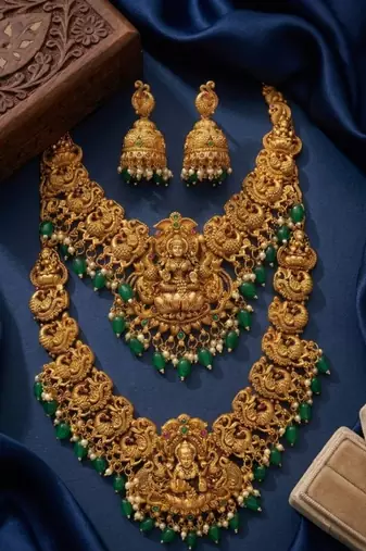 Temple jewelry set with goddess lakshmi pendant, peacock jhumkas & green beads - south indian bridal set