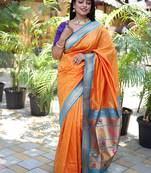Orange paithani silk blend saree with contrast blue zari border