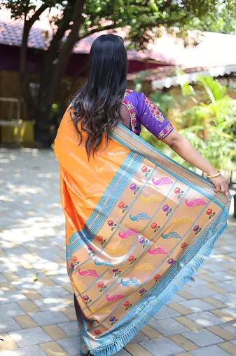 Orange paithani silk blend saree with contrast blue zari border