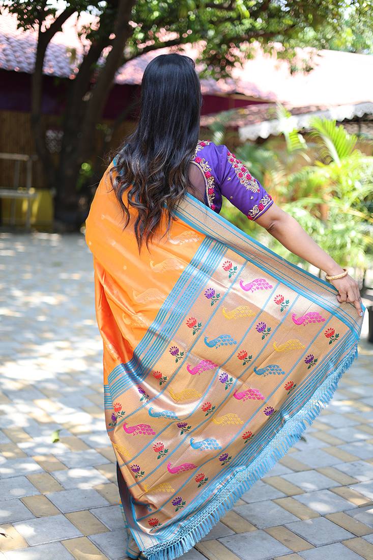 Orange paithani silk blend saree with contrast blue zari border