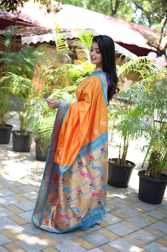 Orange paithani silk blend saree with contrast blue zari border