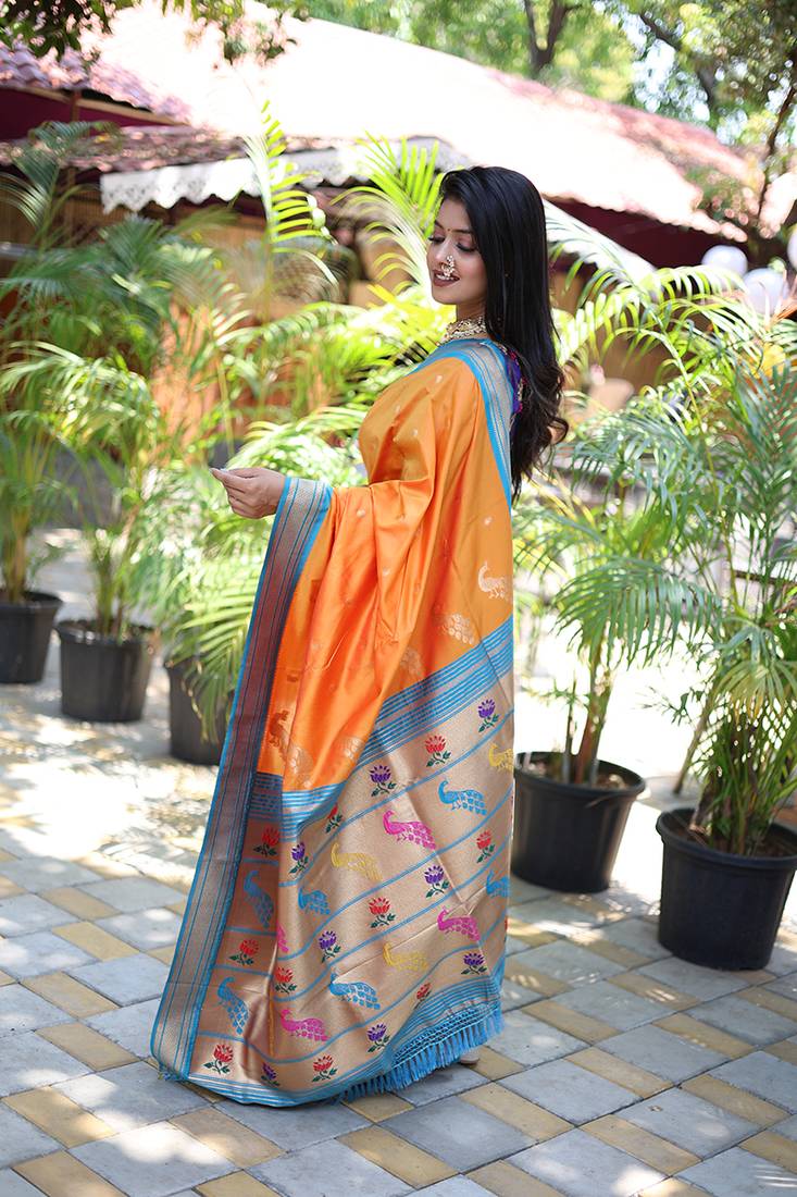 Orange paithani silk blend saree with contrast blue zari border