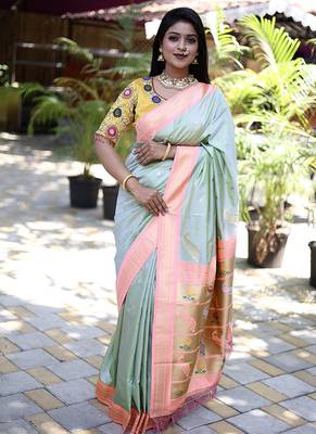 Mint green paithani silk blend saree with contrast peach zari border 1