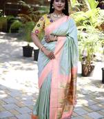 Mint green paithani silk blend saree with contrast peach zari border