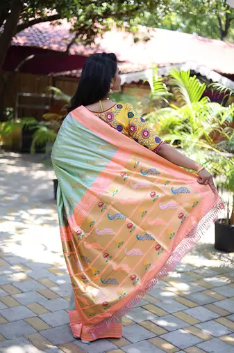 Mint green paithani silk blend saree with contrast peach zari border