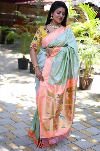 Mint green paithani silk blend saree with contrast peach zari border