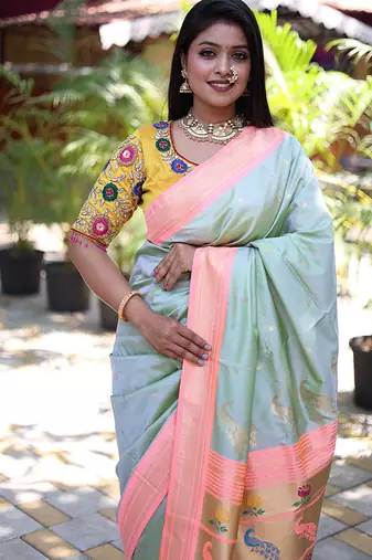 Mint green paithani silk blend saree with contrast peach zari border