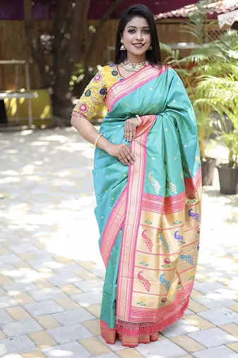Turquoise paithani silk blend saree with contrast pink zari border