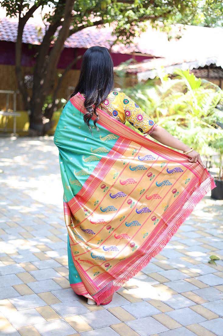 Turquoise paithani silk blend saree with contrast pink zari border