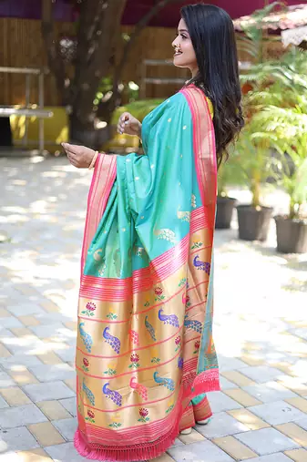 Turquoise paithani silk blend saree with contrast pink zari border