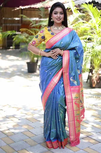 Light blue paithani silk blend saree with contrast pink zari border