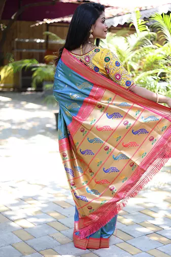 Light blue paithani silk blend saree with contrast pink zari border