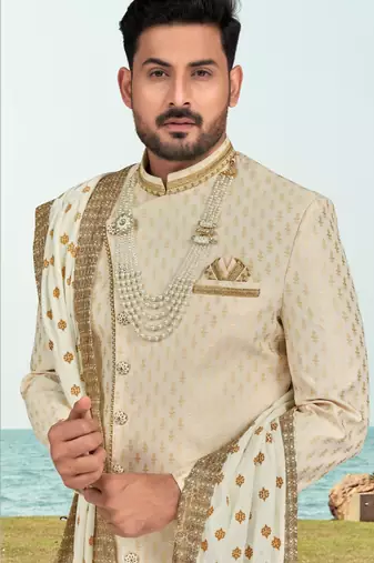 Cream colour havy sherwani set with less, thred & zari hand work