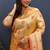 Beige gold silk blend saree with orange floral zari weaving & rich brocade pallu