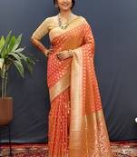 Orange banarasi silk blend saree with zari buti & rich woven border
