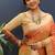 Orange banarasi silk blend saree with zari buti & rich woven border