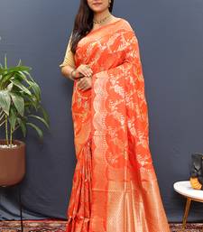 Orange banarasi silk blend saree with gold zari floral weaving & rich pallu