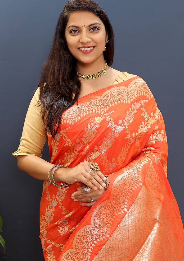 Orange banarasi silk blend saree with gold zari floral weaving & rich pallu