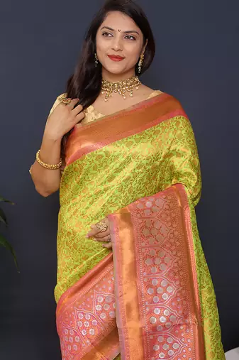 Parrort green banarasi silk blend saree with peach pink zari border & woven pallu