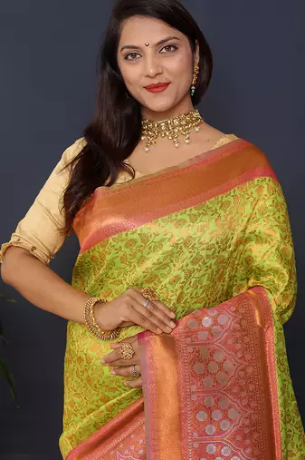 Parrort green banarasi silk blend saree with peach pink zari border & woven pallu