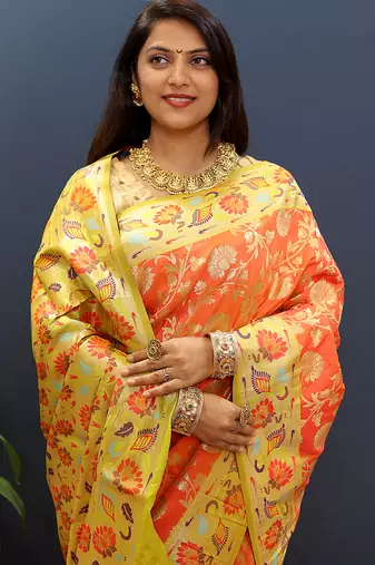 Orange banarasi silk blend saree with multi-color meenakari floral border