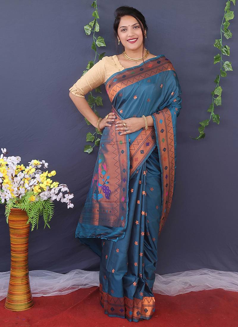 Teal blue banarasi silk blend saree with copper zari butti & geometric woven border