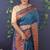 Teal blue banarasi silk blend saree with copper zari butti & geometric woven border