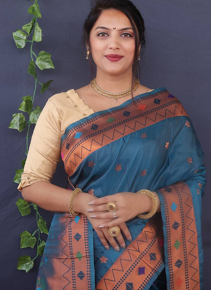 Teal blue banarasi silk blend saree with copper zari butti & geometric woven border