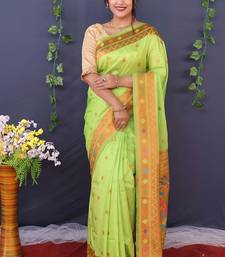 Light green banarasi silk blend saree with copper zari butti & geometric woven border