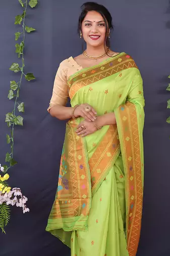Light green banarasi silk blend saree with copper zari butti & geometric woven border