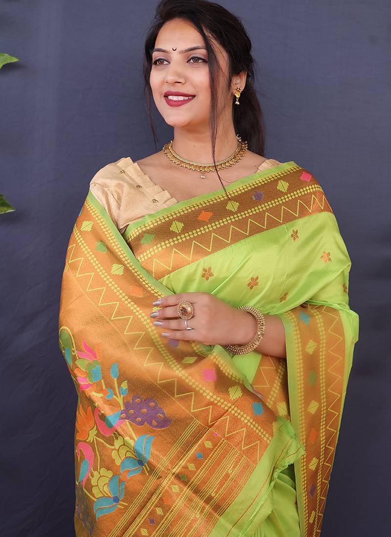 Light green banarasi silk blend saree with copper zari butti & geometric woven border